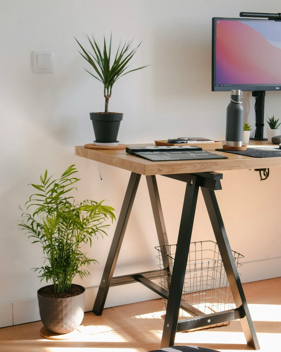 A modern workspace with a smartphone displaying a screen and a computer setup, ideal for business and technology themes.
